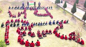 Children make a formation that reads "Jai Hind" during a Republic Day function at their school in Faridabad