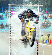 A motorcyclist performs a daredevil act at the closing ceremony of the 58th All-India Police Volleyball Cluster-2010 at the Haryana Police Academy, Maduban, Karnal.