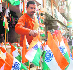 A shopkeeper in Jammu makes preparations for Republic Day by stocking National Flags in Parade Market on Monday.