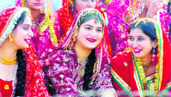 Artistes from various schools wait for their turn during the full dress rehearsal for the Republic Day parade at MA Stadium in Jammu