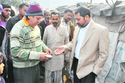 A shopkeeper talks to senior deputy mayor Praveen Bansal in Ludhiana on Monday.
