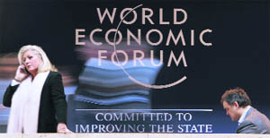 Delegates walk past the logo of the World Economic Forum at the congress centre in Davos on Wednesday.