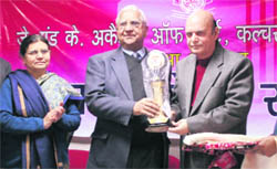 Veteran journalist Ved Bhasin felicitates Jitender Udhampuri (right) at a function organised by the J&K Academy of Arts and Culture at KL Sehgal Hall in Jammu