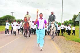 A local athlete runs with the Baton