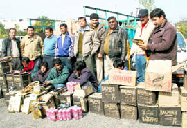 Excise Department employees with the 80 cartons of liquor that were illegally brought from Chandigarh near Dehradun on Thursday