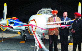 Amritsar Deputy Commissioner Kahan Singh Pannu cuts the ribbon, dedicating the latest Beechbaron aircraft to the Amritsar Aviation Club on Wednesday