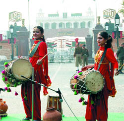 Dressed in traditional Puniabi gear, schoolgirls play dholis on Republic Day at Attari-Wagah joint checkpost in Amritsar