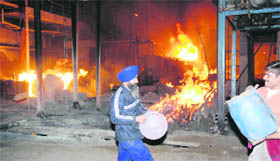 Firemen douse flames at Surya Pharmaceuticals, Banur, on Friday. 