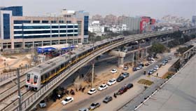 An aerial view of Haryanas maiden Metro train passing through high-rise buildings in Gurgaon