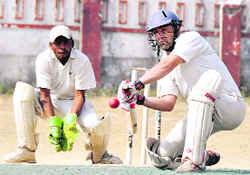 A batsman plays a shot during a match of the 58th District Cricket League in Dehradun on Friday.