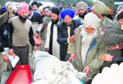 Members of the family perform Ranjodhs last rites in Alhoran village