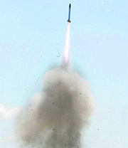 In this January 10, 2010 photo, a test rocket is launched in Lumajang, Indonesia. The 9-foot-long rocket fired by the country's state-owned weapons manufacturer missed its target and crashed into a farm, seriously wounding the owners.