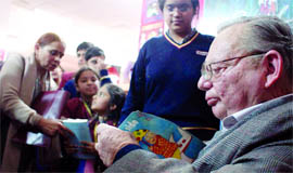 Ruskin Bond signs autographs for children at the fair.