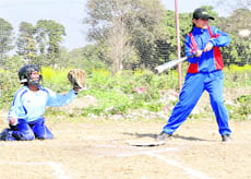 A player hits a shot at the baseball tournament organised by SGRR (PG) College in Dehradun on Saturday.