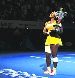 Serena Williams poses with the winners trophy in Melbourne on Saturday.