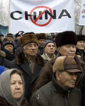 Kazakh riot police detain an opposition supporter during a rally in Almaty on Saturday. Activists held a rally protesting against the decision of the government to loan a plot of territory to China for growing crops.