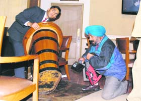 A policeman conducts a search at Hotel Mountview after a hoax bomb call in Chandigarh