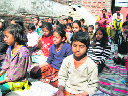 Underprivileged children participate in the Art of Living camp at Shridev Suman Nagar in Dehradun on Sunday.