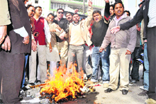 Members of the BJP Yuva Morcha protest against price rise at the Clock Tower in Dehradun on Sunday.