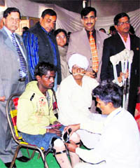 A physically handicapped person gets a prosthetic device at a Viklang Sahayta Camp in Ludhiana on Sunday