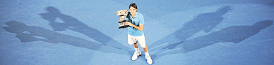 Roger Federer poses with the winners trophy in Melbourne on Sunday. Federer defeated Andy Murray 6-3, 6-4, 7-6.