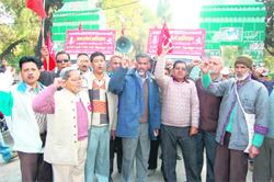 CPI workers stage a protest against rising prices of essential commodities at the Gandhi Park in Dehradun on Monday.