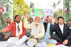Members of the UKD stage a dharna near the Gandhi Park in Dehradun on Sunday. 