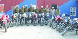 Police officials along with the recovered 14 stolen motorcycles at Phagwara on Monday.