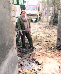 A woman shows the damaged portion from where 25 unidentified persons tried to trespass into the disputed land in Ludhiana
