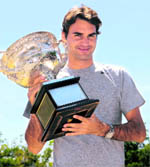 Roger Federer with the Australian Open trophy, on the bank of the Yarra River in Melbourne on Monday