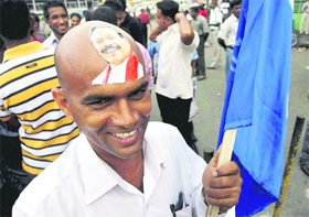 Sri Lankan President Mahinda Rajapaksa's photograph is seen pasted on a supporter's forehead, in Colombo on Monday. 