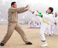 A student shows tae kwon do skills during the annual sports meet organised by Ryan International School in Patiala on Tuesday.