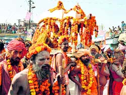 Saints carry a deity in a palanquin during a Shahi Peshwayi in Haridwar