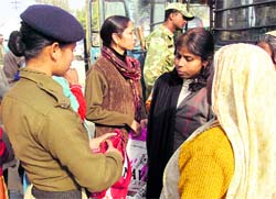 Security personnel frisk people in Haridwar on Tuesday