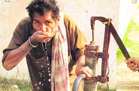 A resident of Mandhora village, near Ambala, drinks water from a handpump believed to be polluted