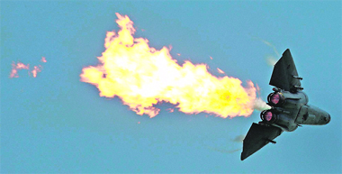 An F-111 of the Royal Australian Air Force showcases a fuel dump and burn procedure during a display on the opening day of the Singapore Airshow 2010, Asia's largest aerospace and defence exhibition, on Tuesday 