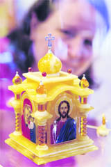 A visitor looks at a chapel, made of gold, silver and amber, exhibited during the 18th Forum of Jewellery Industry Junwex in St.Petersburg on Wednesday