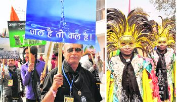 Masked artistes lend colour; placards with social messages during a Peshwayi procession in Haridwar on Wednesday.
