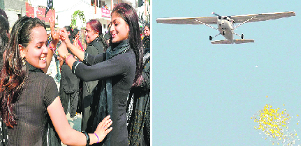 An aircraft showers petals and coloured paper; girls from Delhi dance to the tune of bhangra.