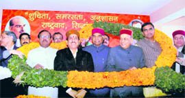Newly elected state BJP president Khimi Ram being greeted by Chief Minister Prem Kumar Dhumal and other members of the party in Shimla on Wednesday