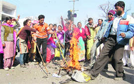 Residents, whose houses were demolished during Wednesdays anti-encroachment drive, burn the MC effigy in Dehradun on Thursday.