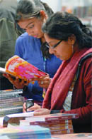 Girls check out books at World Book Fair in New Delhi on Friday.