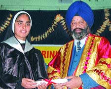 Guru Nanak Dev University Registrar Inderjeet Singh gives away a degree to a Trinity College student in Jalandhar