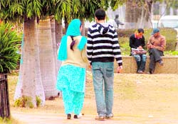 Students take a stroll on the Jammu University campus on Friday. Following a change in the temperature, they have started studying in the open