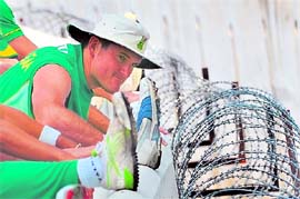 Graeme Smith stretches during a practice session in Nagpur on Friday. The first of the two-match Test series against India begins at the new Vidarbha Cricket Association ground on the outskirts of the city on Saturday