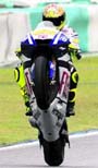 Yamaha MotoGP rider Valentino Rossi of Italy makes a wheelie during the 2010 pre-season test at Sepang circuit outside Kuala Lumpur on Friday