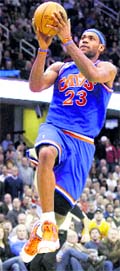 Cleveland Cavaliers LeBron James puts up a shot during the fourth quarter against Miami Heats in Cleveland, on Thursday