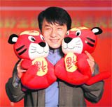 Actor Jackie Chan poses with two tiger toys during a ceremony to launch a tiger protection project with WildAid in Beijing on Friday.