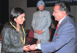 Justice DK Jain of the Supreme Court honours a student at a function in Kurukshetra