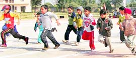 Tiny tots of Peace Public School take part in a race during the annual sports day
